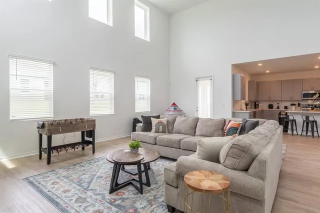 a living room with furniture wooden floor and a window