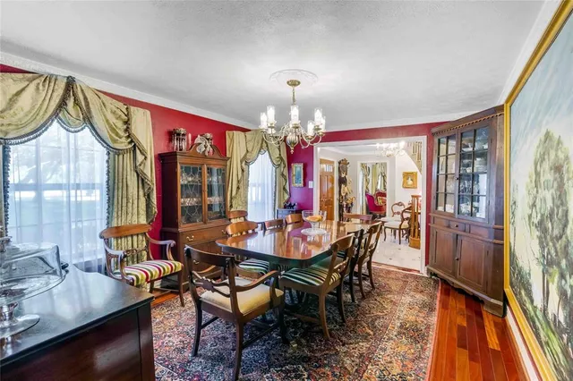 a view of a dining room with furniture wooden floor and chandelier