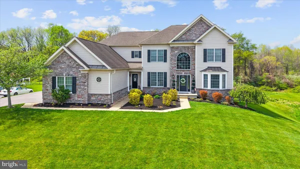 a view of a house with backyard sitting area and garden
