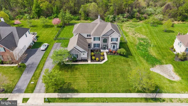 a view of a house with backyard and a tree