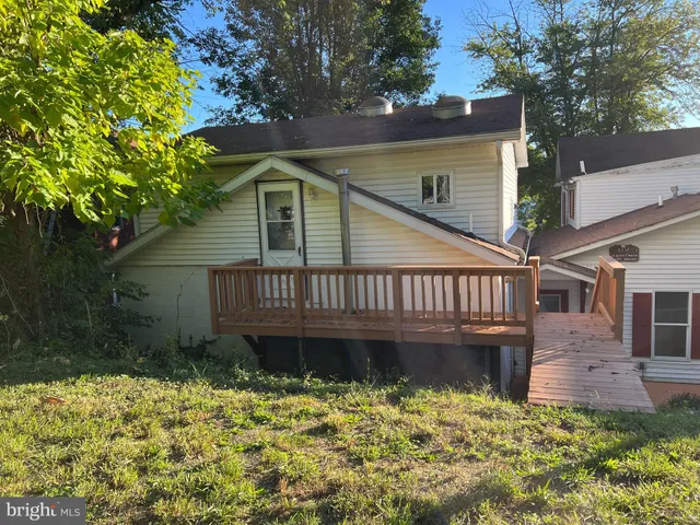 a view of a room with wooden floor and staircase