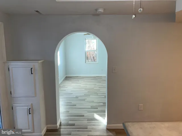 a view of a room with wooden floor and electronic appliances