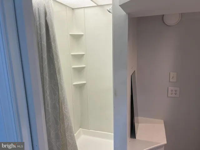 a kitchen with granite countertop white cabinets and sink