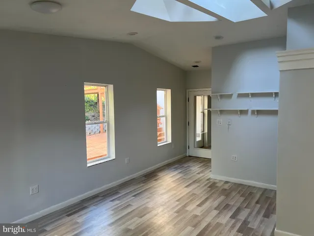 a view of a hallway with a glass door and shower