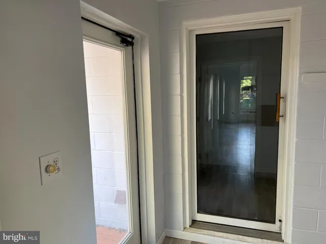 a view of a hallway with wooden floor and closet