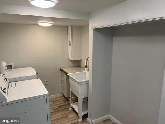 a kitchen with a refrigerator a stove top oven and a sink