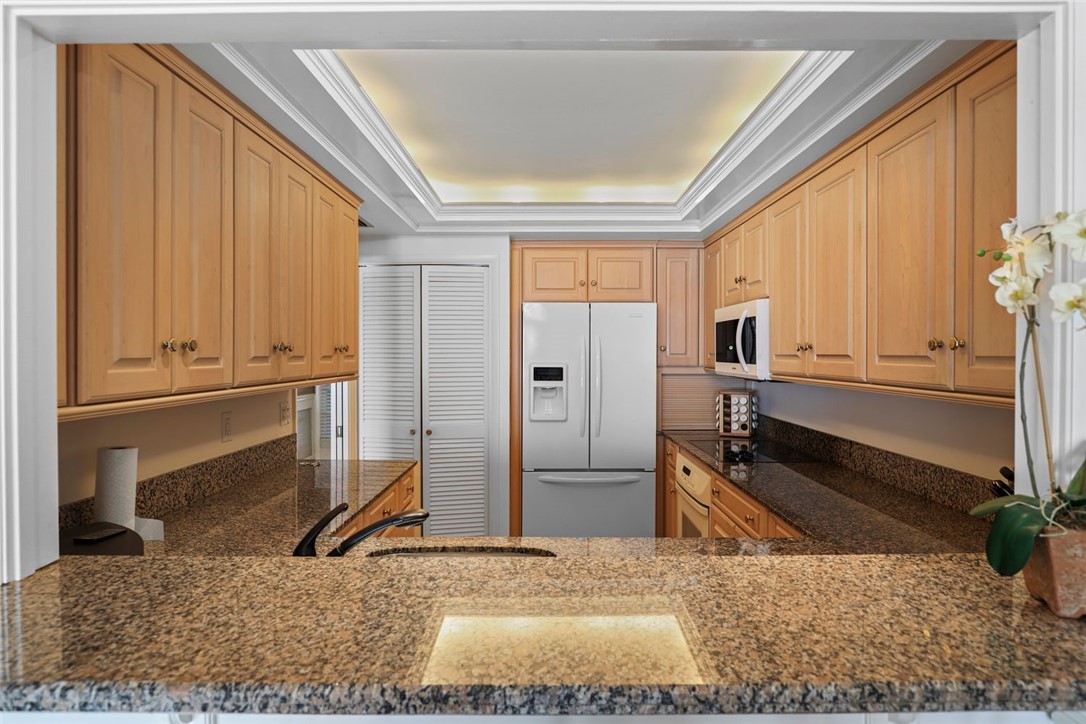 1001 Bay Road, Unit 302 Vero Beach, FL 32963 - Photo 12 of 31 a view of a kitchen with a sink and a window