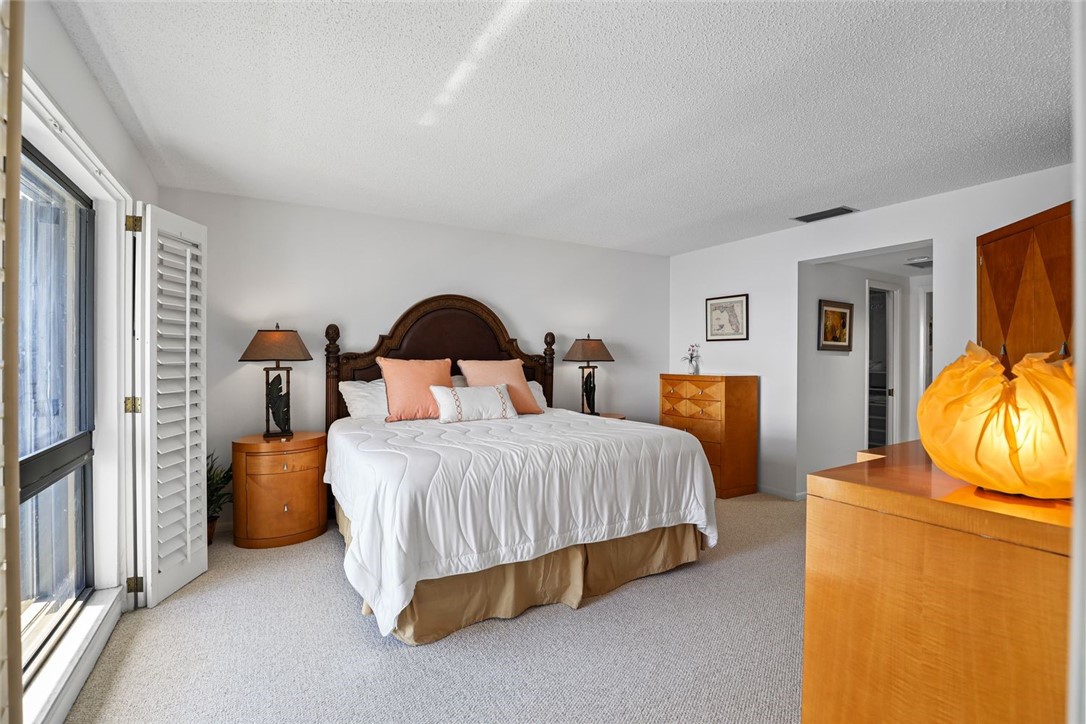 1001 Bay Road, Unit 302 Vero Beach, FL 32963 - Photo 13 of 31 a bedroom with bed and window