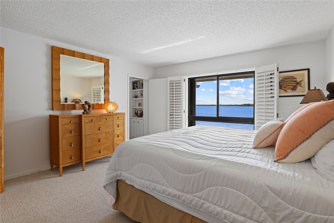 1001 Bay Road, Unit 302 Vero Beach, FL 32963 - Photo 15 of 31 a bedroom with a bed and a dresser