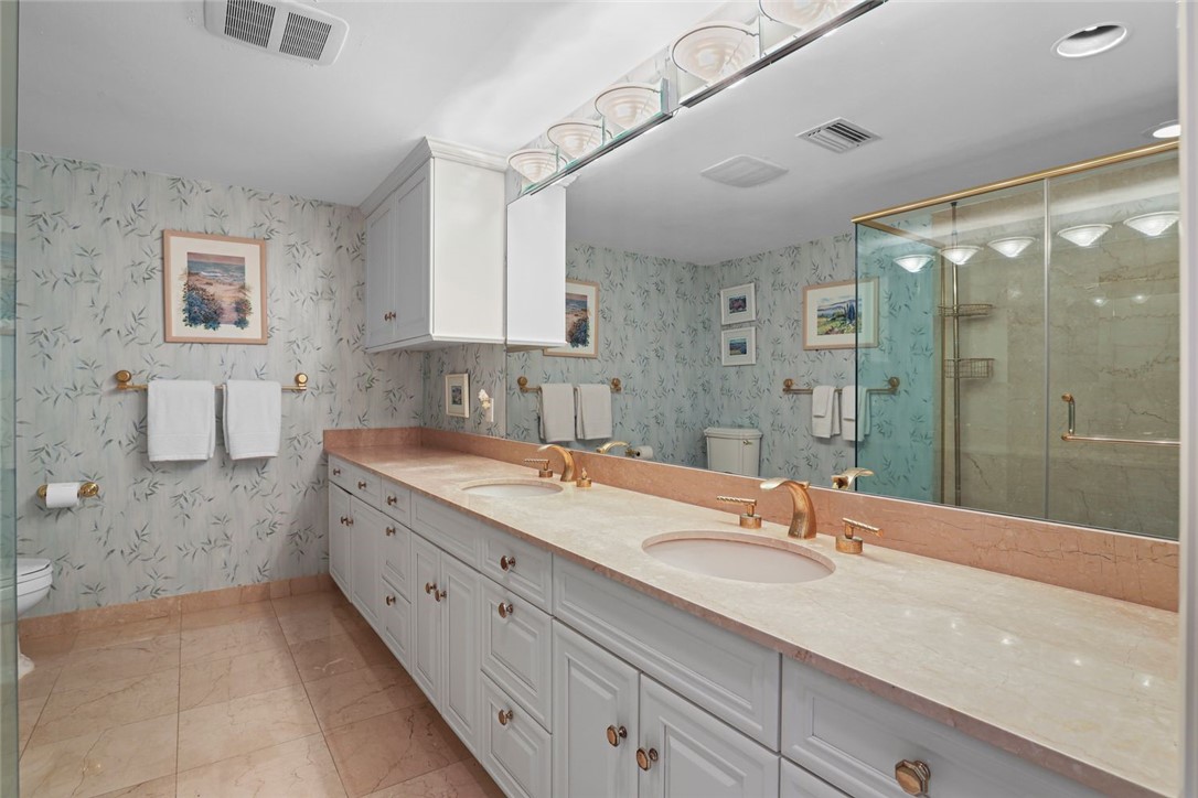 1001 Bay Road, Unit 302 Vero Beach, FL 32963 - Photo 16 of 31 a bathroom with a granite countertop sink mirror and double