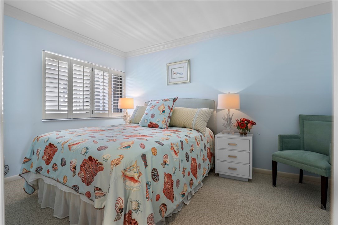 1001 Bay Road, Unit 302 Vero Beach, FL 32963 - Photo 18 of 31 a bedroom with a bed and a couch