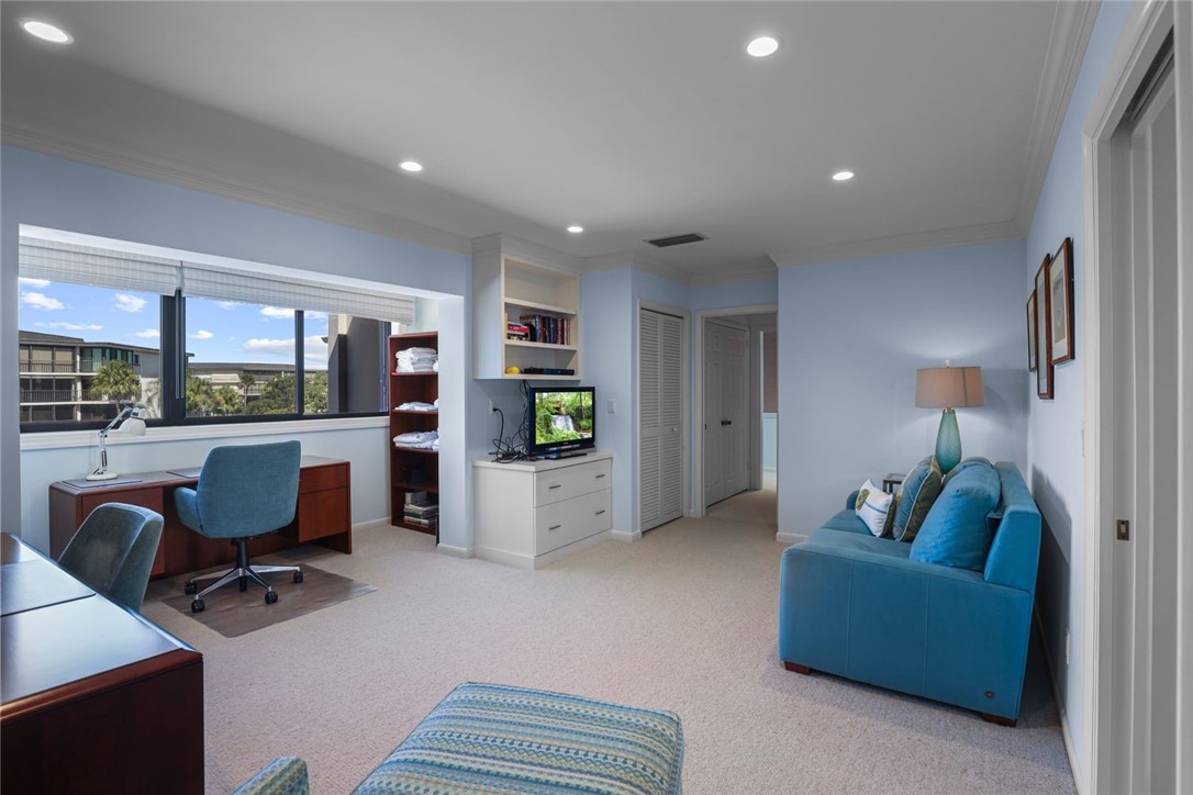 1001 Bay Road, Unit 302 Vero Beach, FL 32963 - Photo 24 of 31 a living room with furniture and a flat screen tv