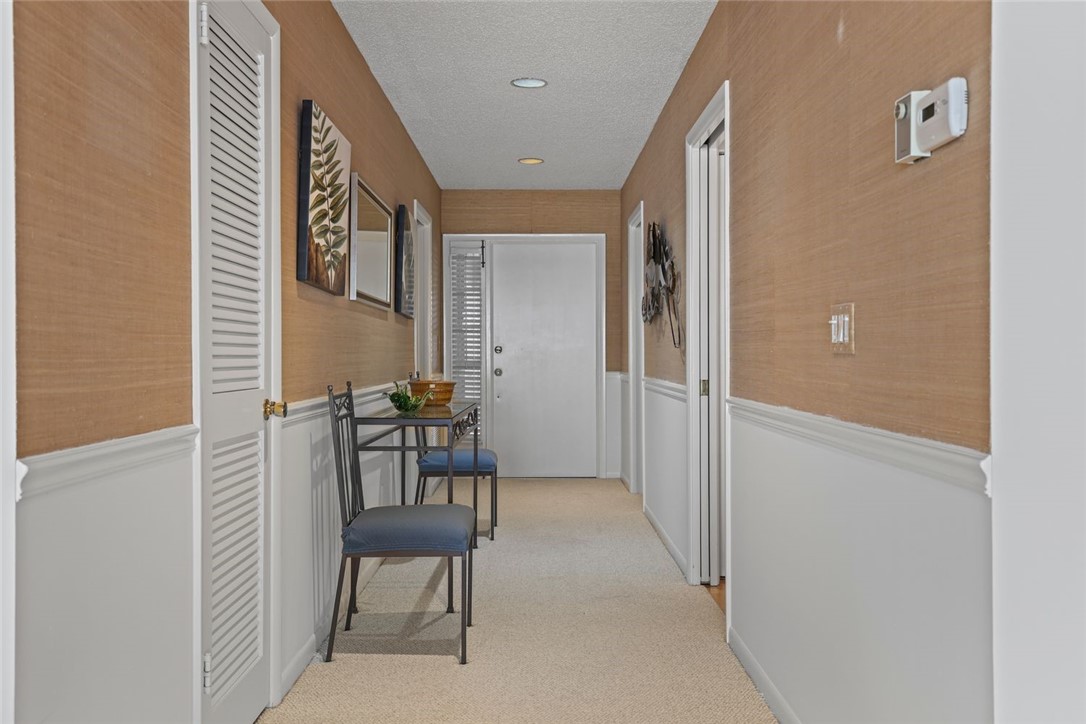 1001 Bay Road, Unit 302 Vero Beach, FL 32963 - Photo 4 of 31 a view of a hallway with chair and table