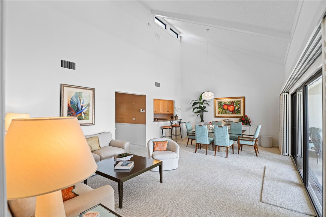 1001 Bay Road, Unit 302 Vero Beach, FL 32963 - Photo 5 of 31 a living room with furniture and a rug