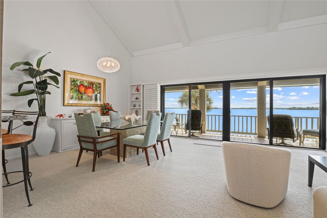 1001 Bay Road, Unit 302 Vero Beach, FL 32963 - Photo 6 of 31 a living room with furniture and large windows