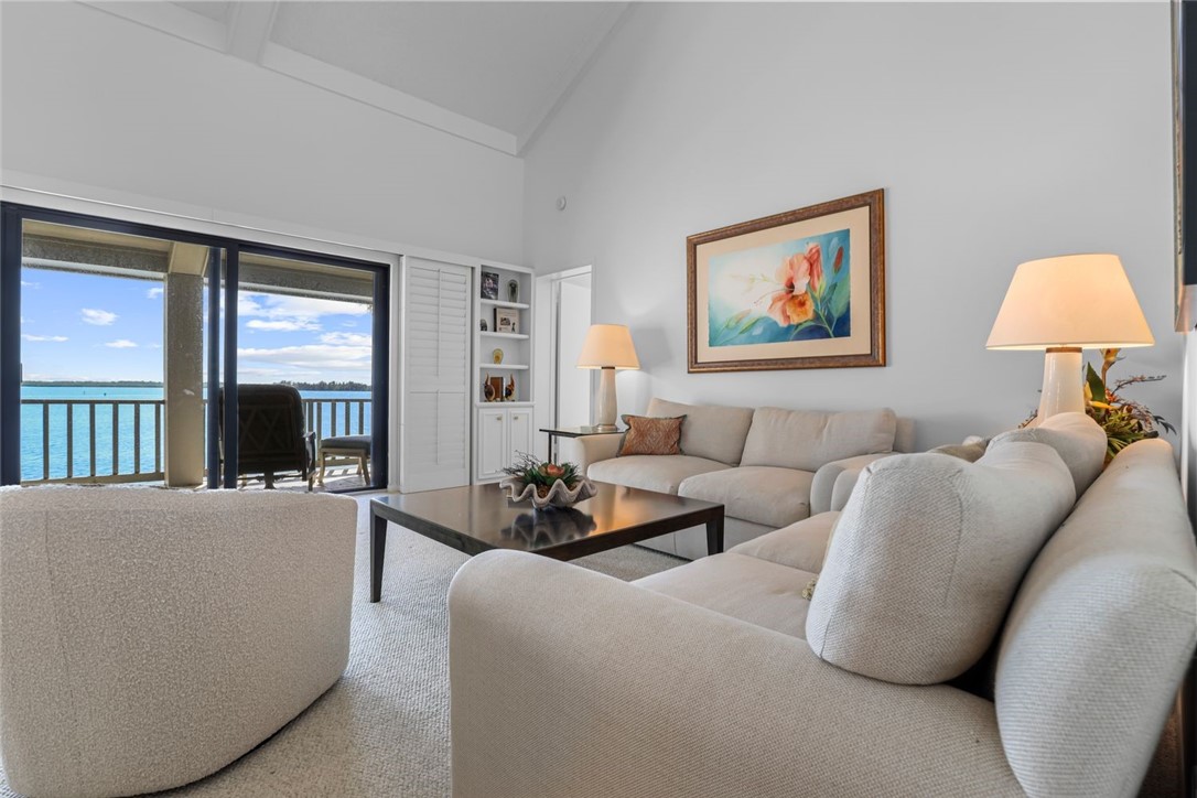1001 Bay Road, Unit 302 Vero Beach, FL 32963 - Photo 9 of 31 a living room with furniture and a window
