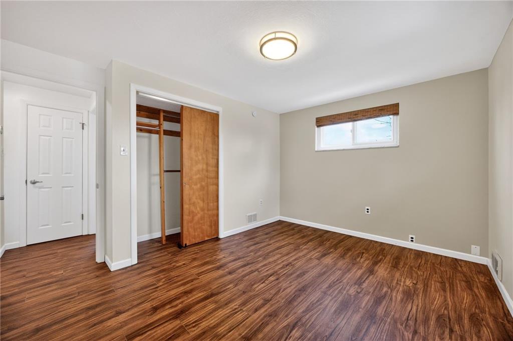 616 Lane Way Pittsburgh, PA 15227 - Photo 17 of 17 an empty room with wooden floor and windows