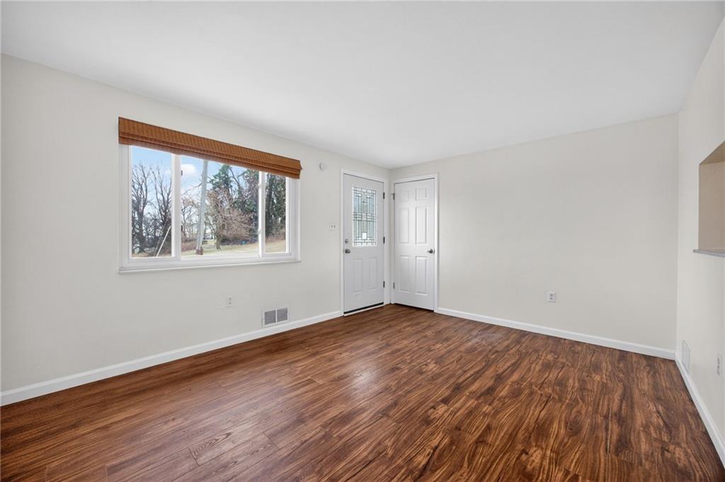 616 Lane Way Pittsburgh, PA 15227 - Photo 6 of 17 a view of empty room with wooden floor and fan