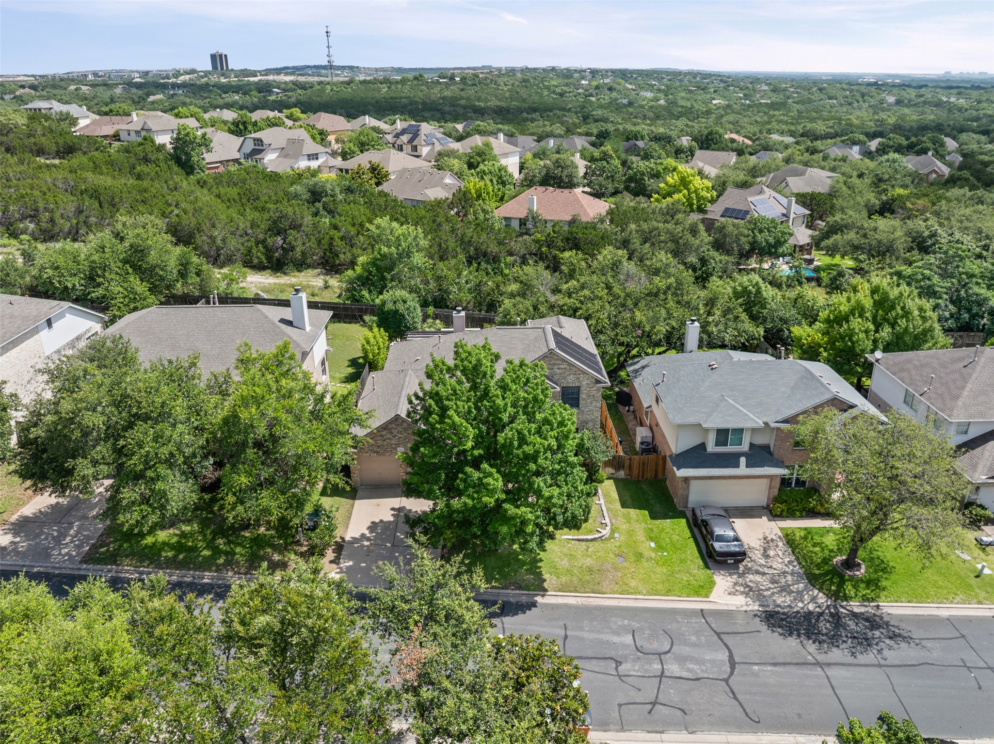 8820 Colberg Drive Austin, TX 78749 - Photo 34 of 35 An aerial perspective reveals a tree-lined neighborhood with well-maintained homes and lush greenery.