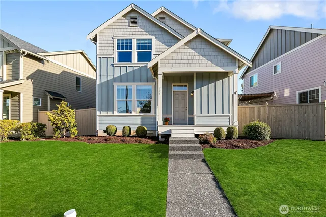 a front view of a house with a yard and outdoor seating