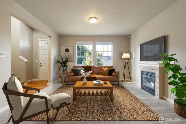 a living room with furniture and a fireplace