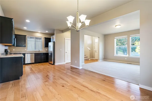 a view of kitchen with sink microwave and refrigerator