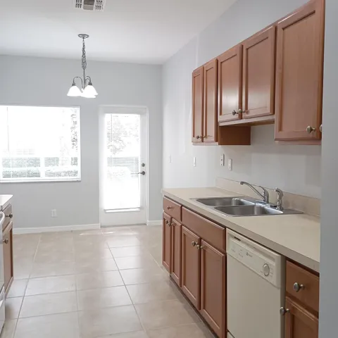 a kitchen with a sink stove and cabinets