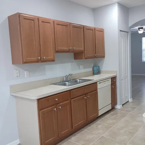 a kitchen with stainless steel appliances granite countertop a sink and a white cabinets