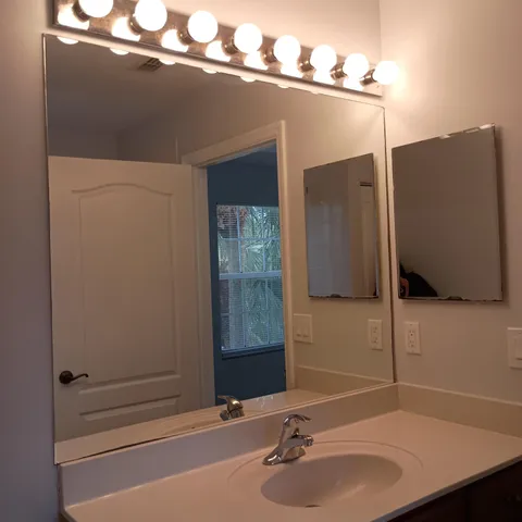 a bathroom with a sink and a mirror