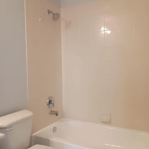 a bathroom with a bathtub and toilet