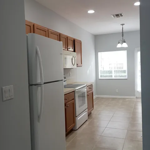 a kitchen with stainless steel appliances a refrigerator sink and microwave