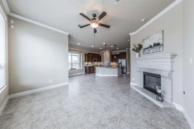 a view of a livingroom with a fireplace and a ceiling fan