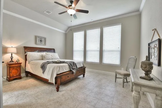 a spacious bedroom with a bed and window