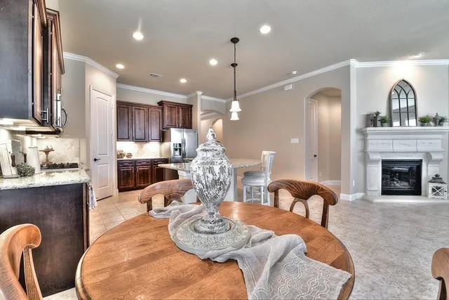 a living room with furniture kitchen view and a fireplace