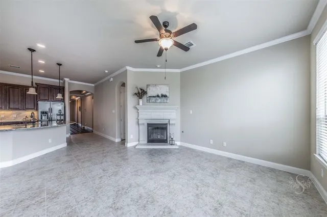 a view of a livingroom with a fireplace and a ceiling fan