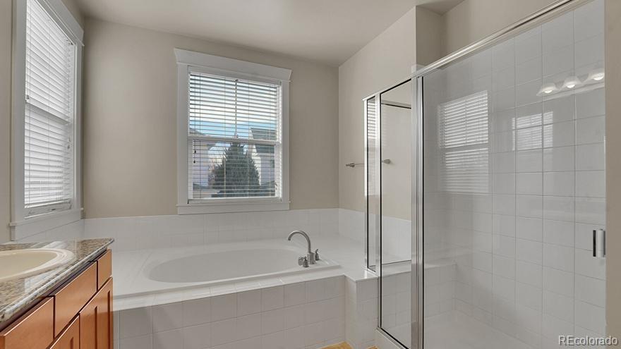 11718 Perry Street Westminster, CO 80031 - Photo 12 of 15 a bathroom with a bathtub and a sink
