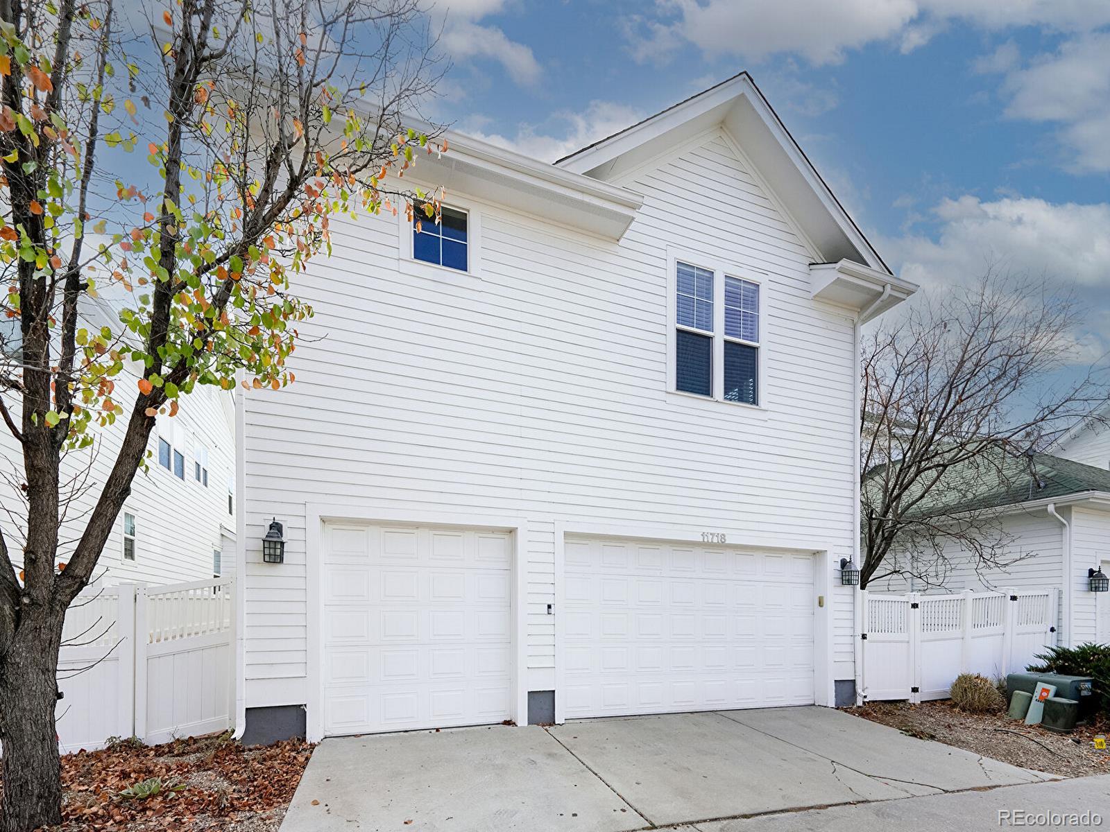 11718 Perry Street Westminster, CO 80031 - Photo 13 of 15 a view of a white house with a large tree