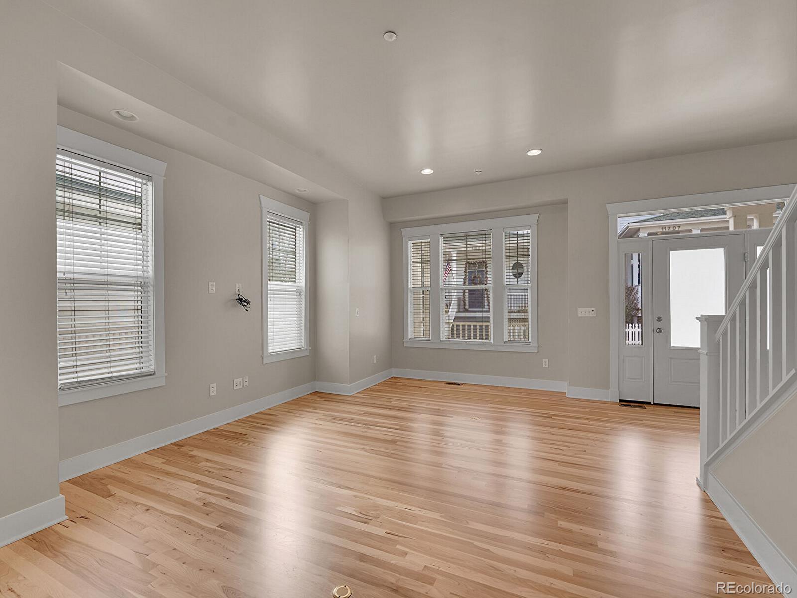 11718 Perry Street Westminster, CO 80031 - Photo 14 of 15 a view of an empty room with wooden floor and a window