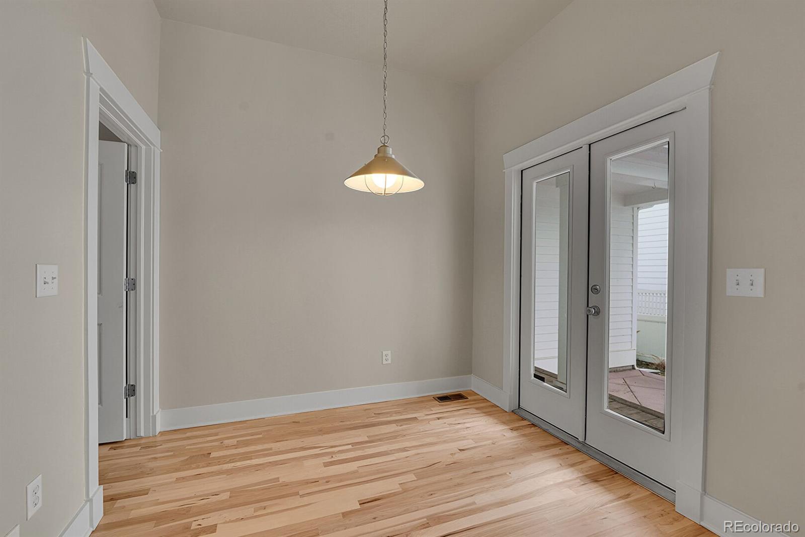 11718 Perry Street Westminster, CO 80031 - Photo 7 of 15 a view of a room with wooden floor and fan