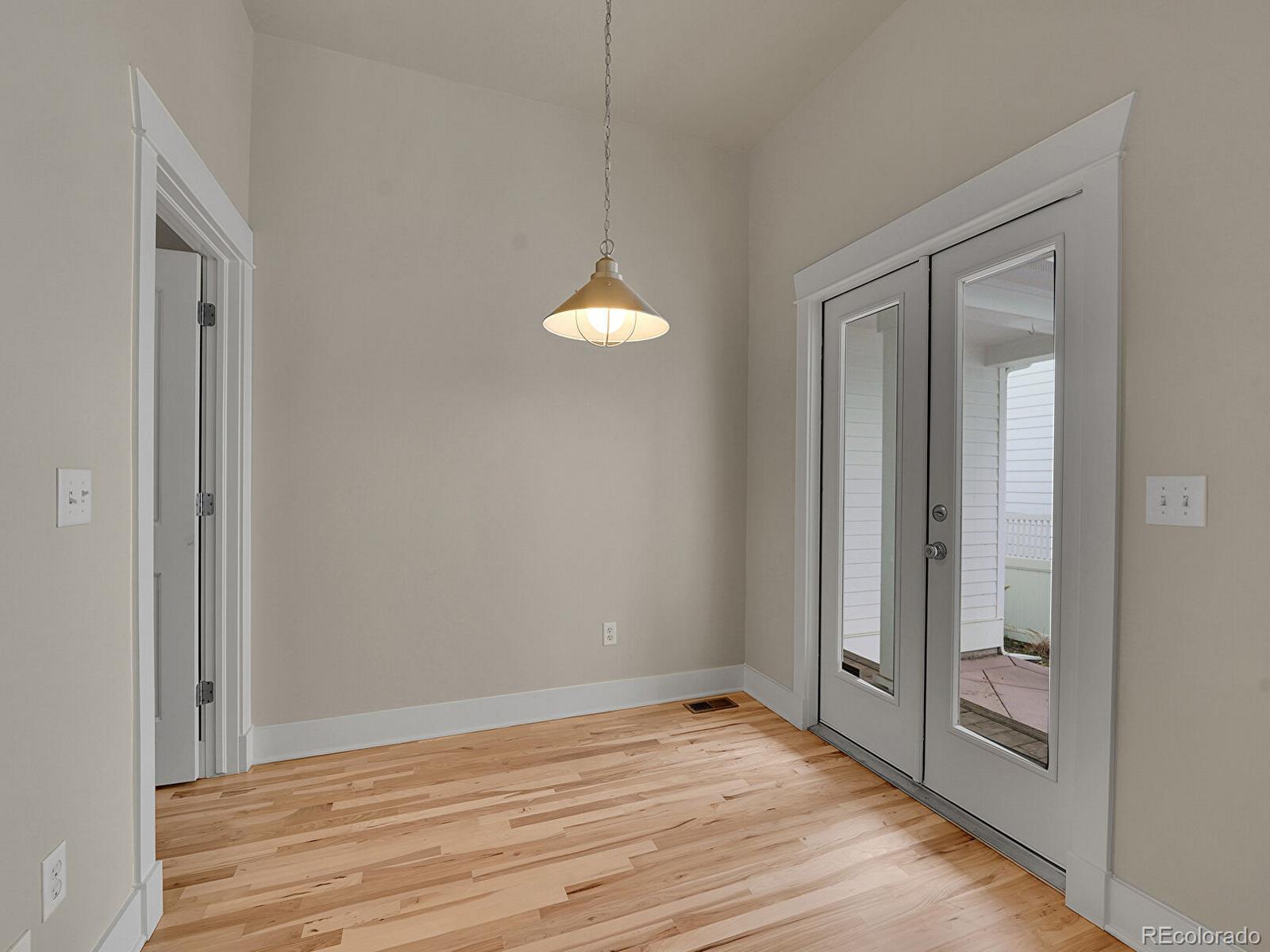 11718 Perry Street Westminster, CO 80031 - Photo 9 of 15 a view of a room with wooden floor and fan