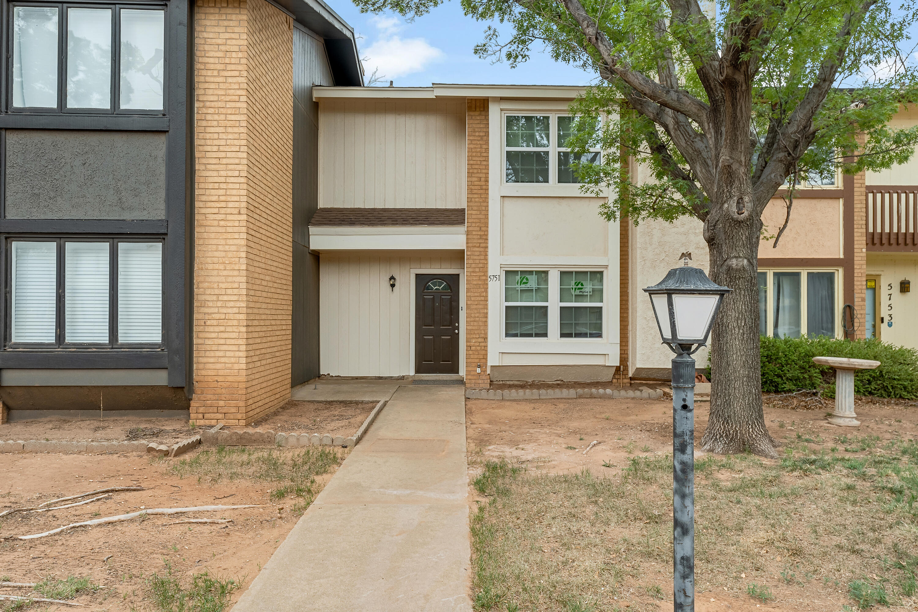5751 38th Street Lubbock, TX 79407 - Photo 1 of 22 a front view of a house with a yard and garage