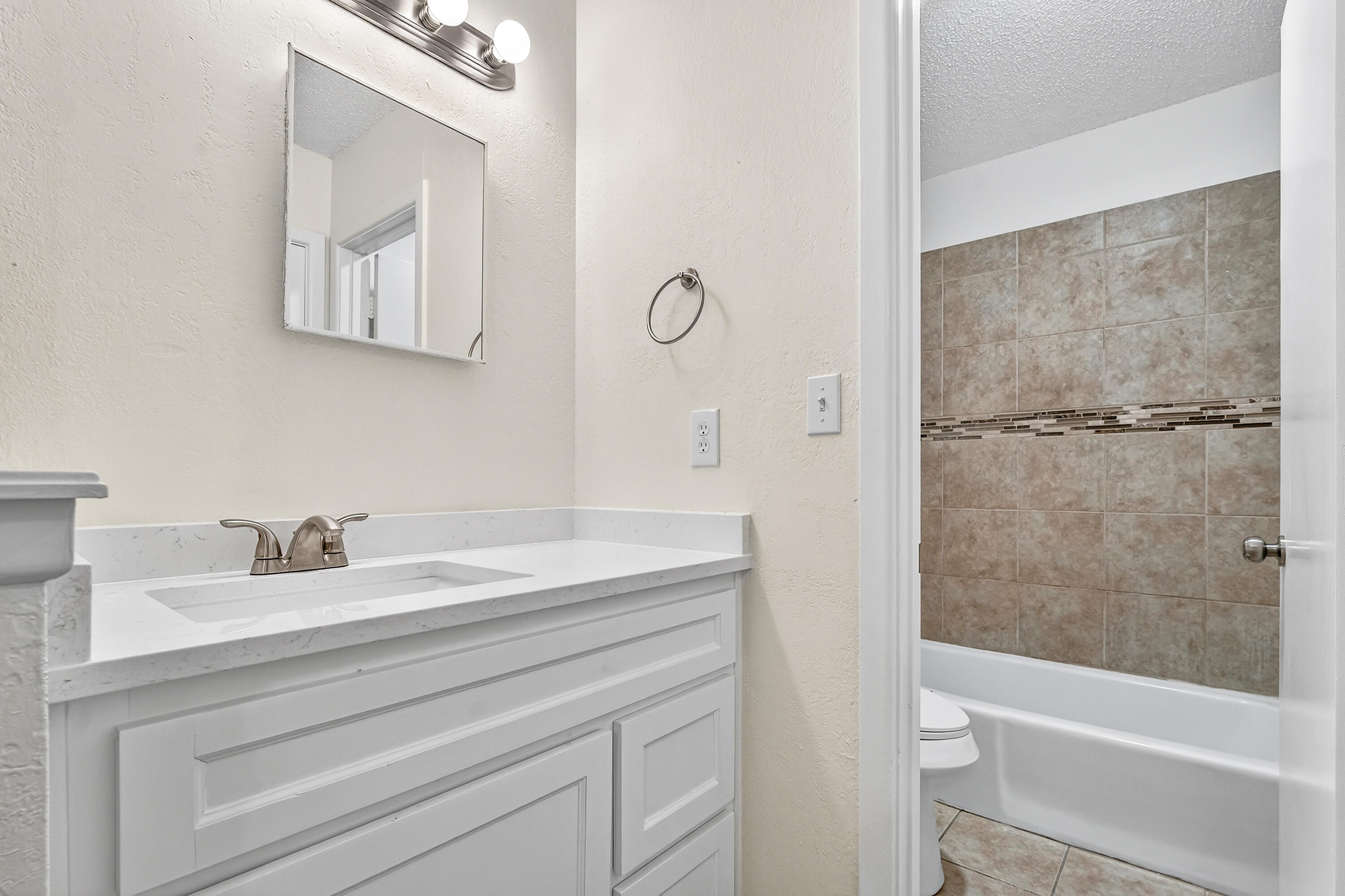 5751 38th Street Lubbock, TX 79407 - Photo 16 of 22 a bathroom with a sink and a mirror