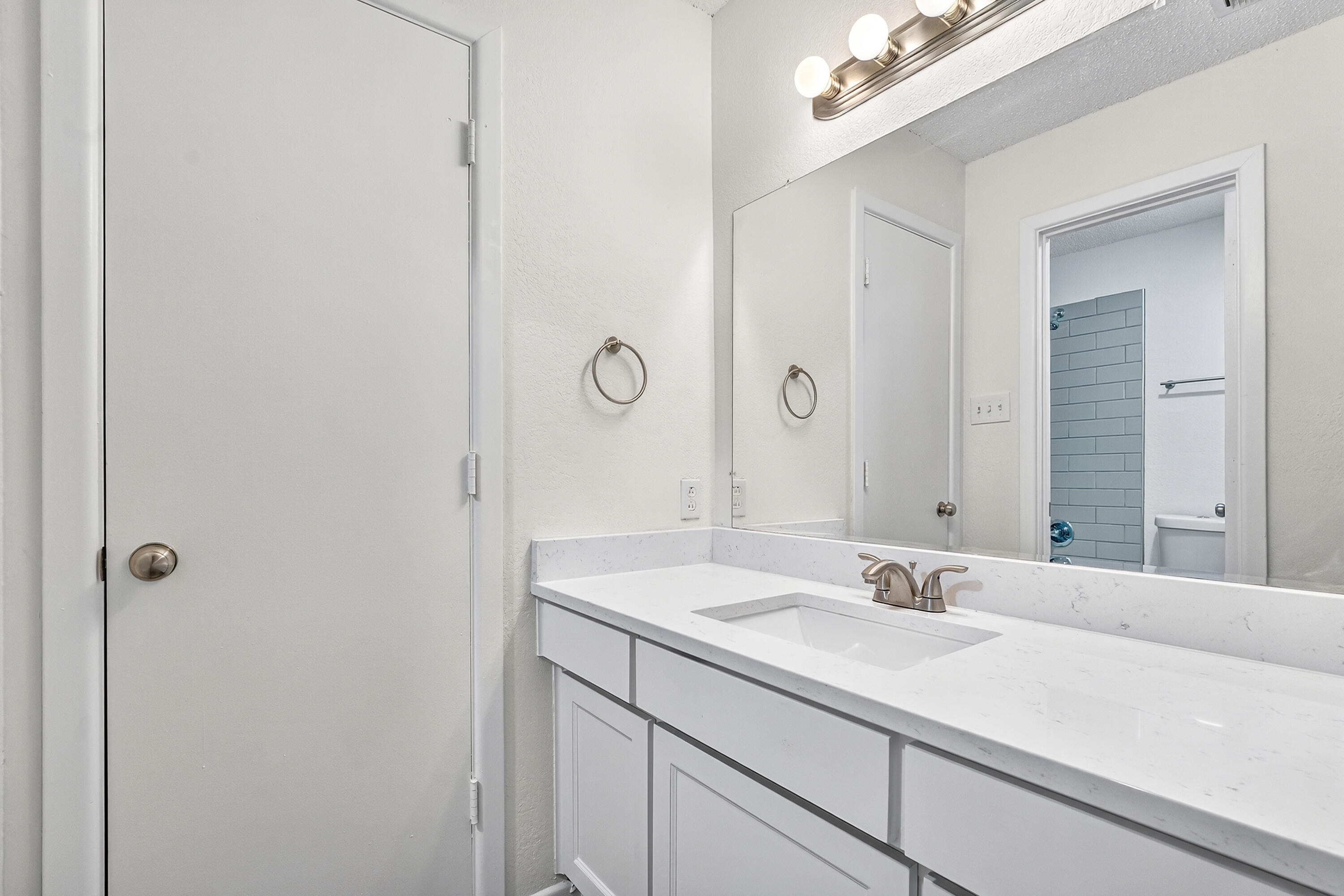 5751 38th Street Lubbock, TX 79407 - Photo 17 of 22 a bathroom with a sink and a mirror