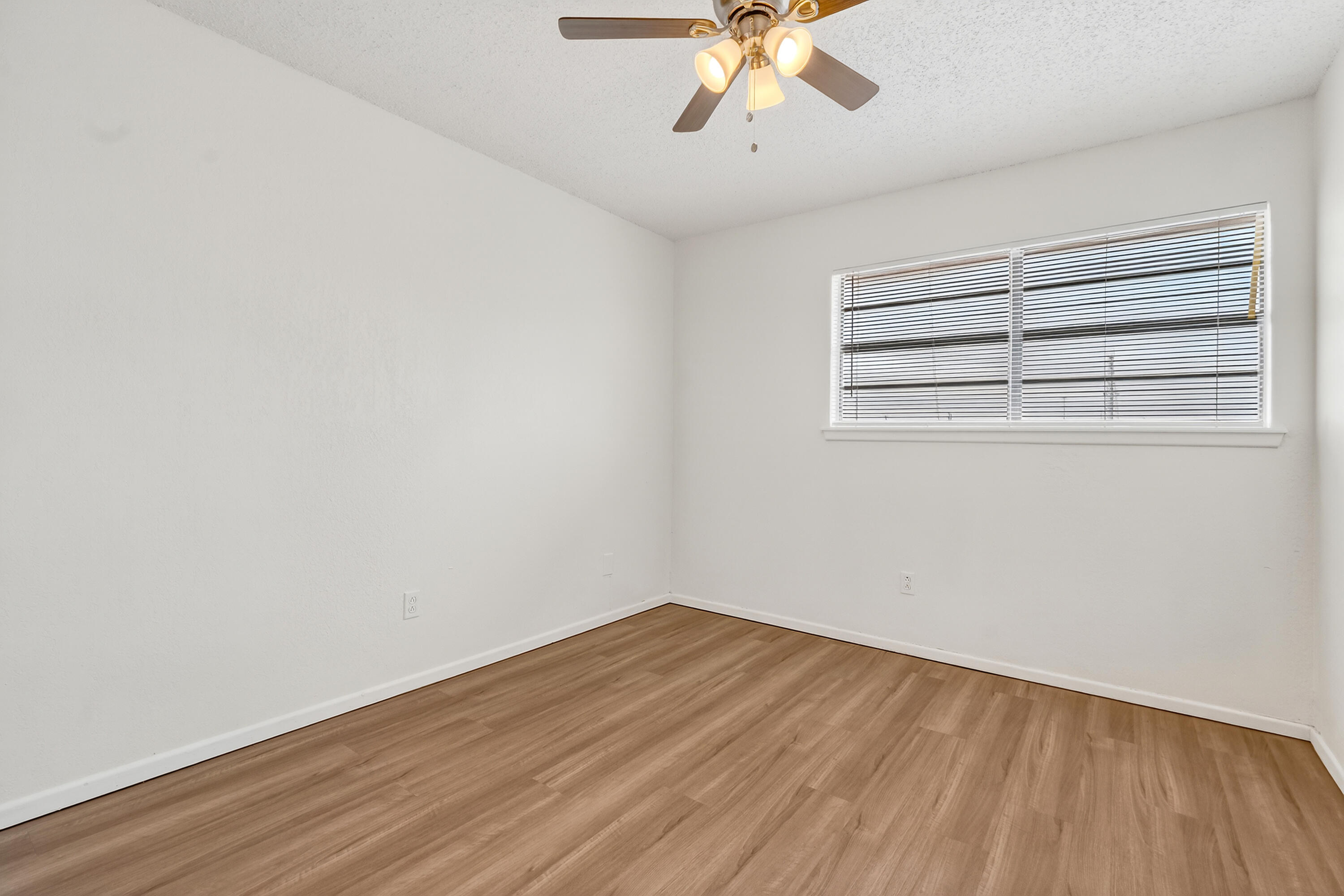 5751 38th Street Lubbock, TX 79407 - Photo 19 of 22 a view of a room with wooden floor and fan
