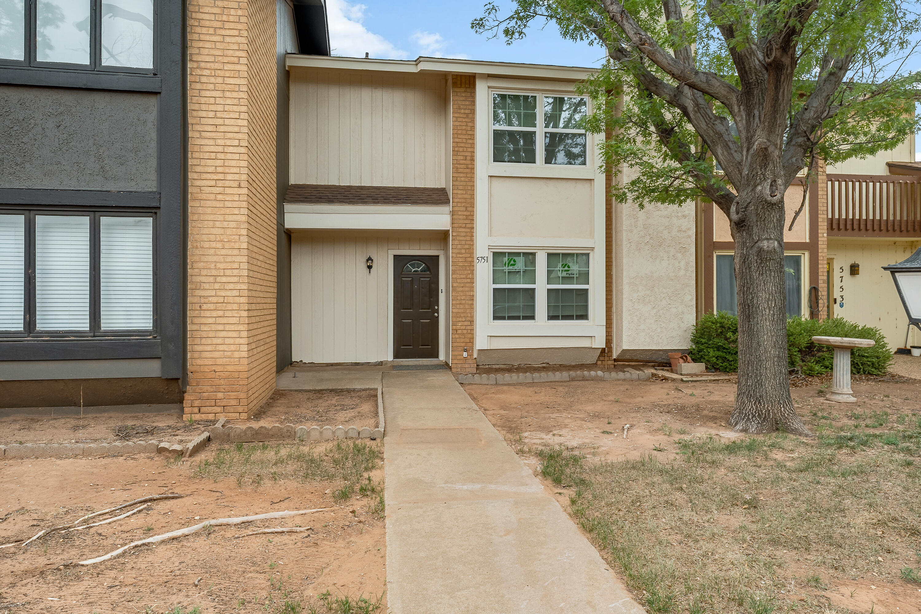 5751 38th Street Lubbock, TX 79407 - Photo 2 of 22 a front view of a house with a yard and garage