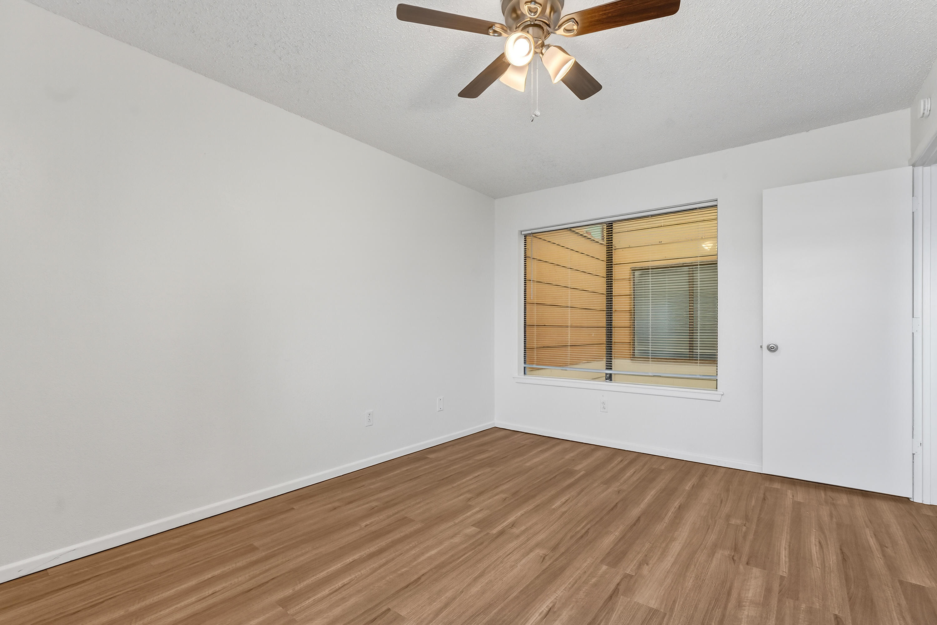 5751 38th Street Lubbock, TX 79407 - Photo 22 of 22 a view of an empty room with wooden floor and a window