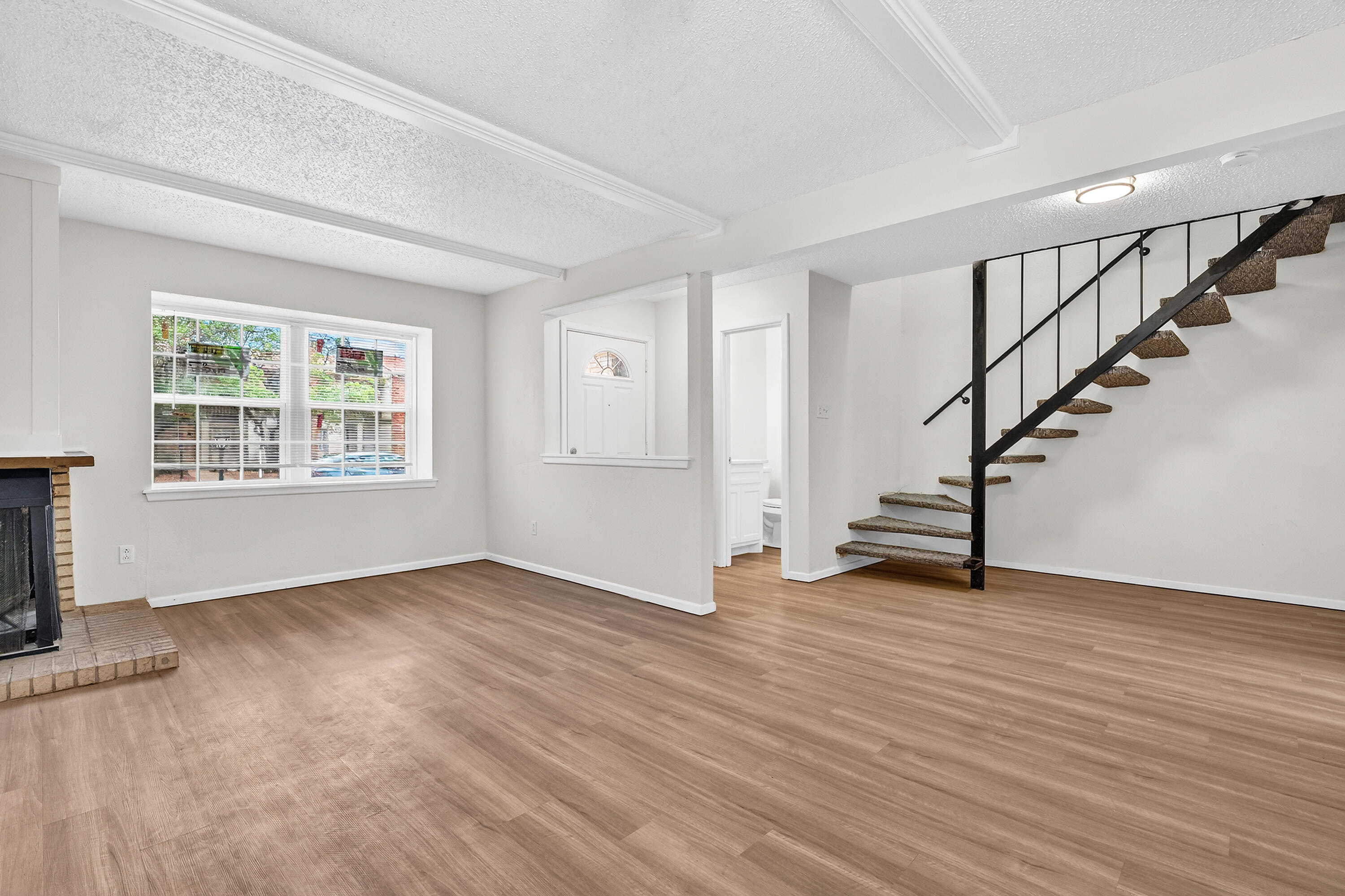5751 38th Street Lubbock, TX 79407 - Photo 6 of 22 a view of an empty room with wooden floor and a window