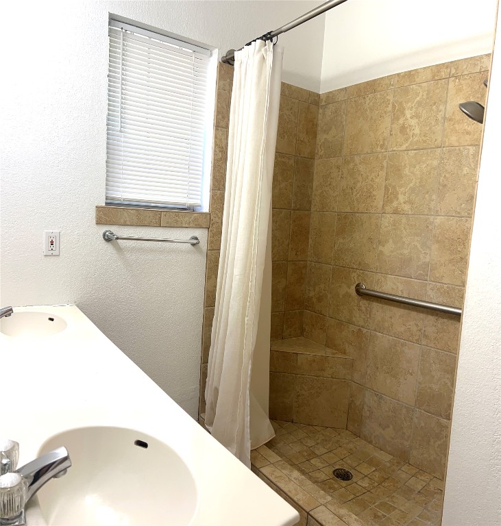 1747 Windy Park Circle Round Rock, TX 78664 - Photo 11 of 12 a bathroom with a bathtub and a shower