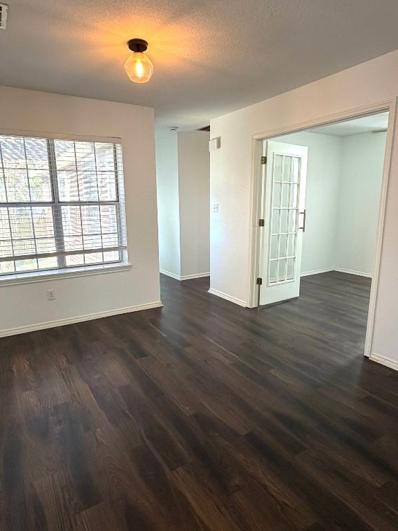 1747 Windy Park Circle Round Rock, TX 78664 - Photo 6 of 12 an empty room with wooden floor and windows