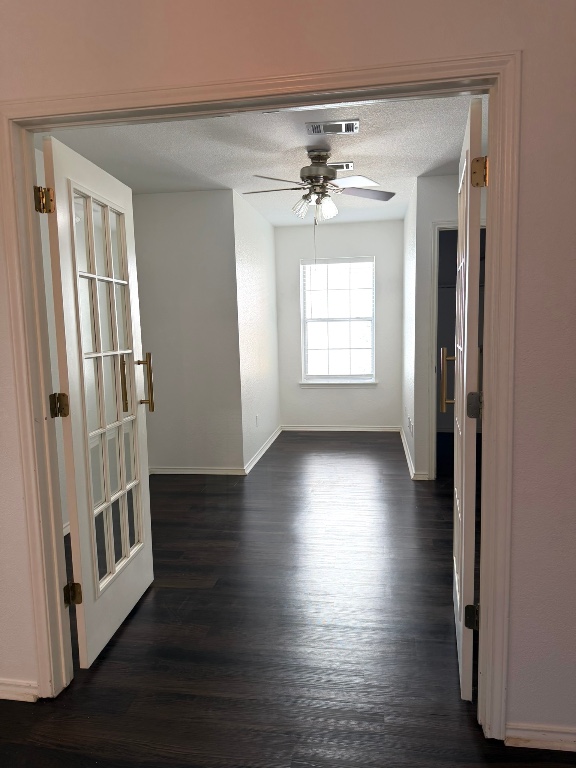 1747 Windy Park Circle Round Rock, TX 78664 - Photo 7 of 12 an empty room with wooden floor and windows